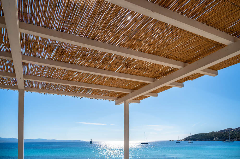 roof structure made of bamboo mats in front of a beautiful beach
